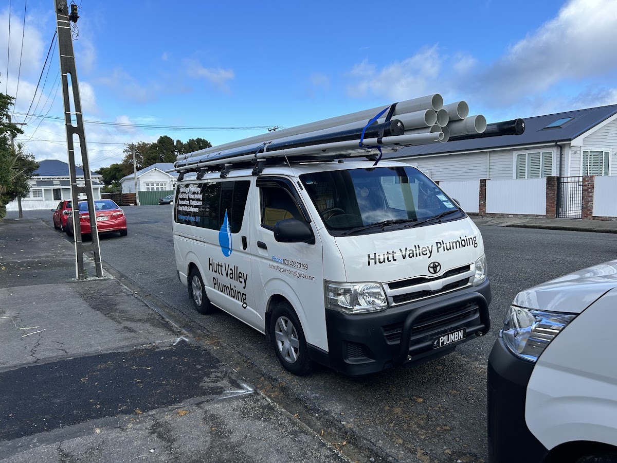 The Hutt Valley Plumbing van with pipes on the roof rack, signwritten with services and contact details